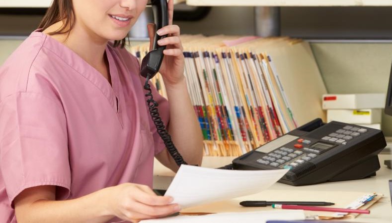 Administrative assistant on phone with patient