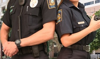 Male and female security officer in side pose